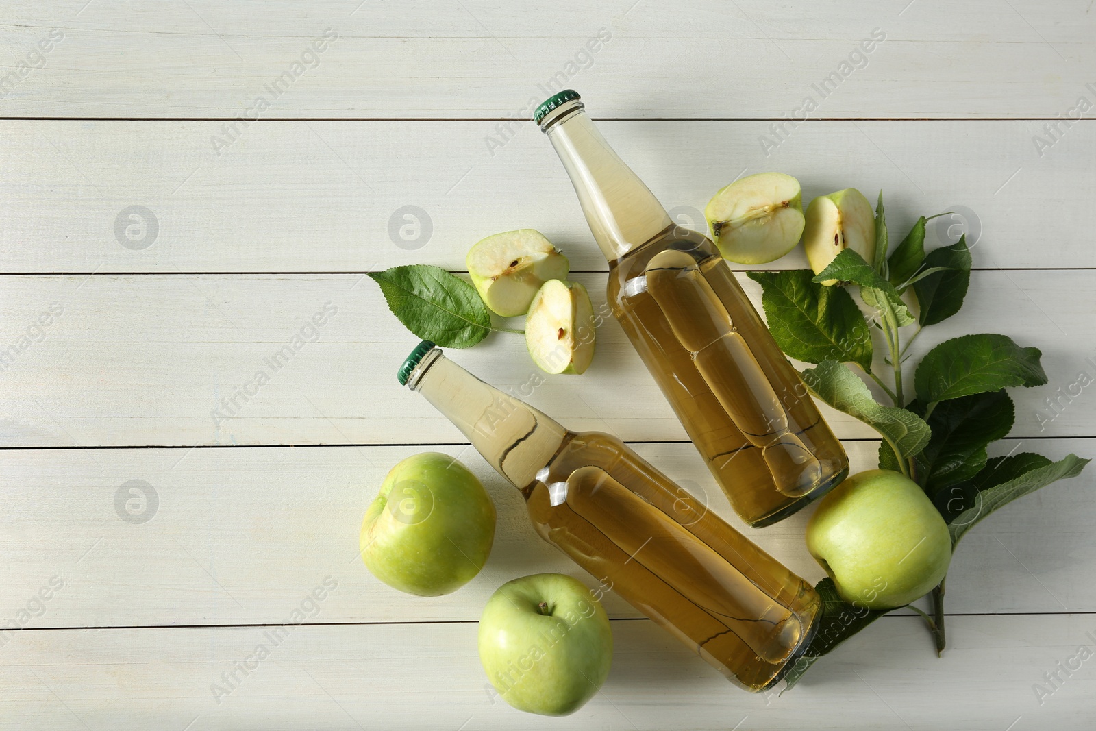 Photo of Flat lay composition with delicious apple cider on white wooden table, space for text