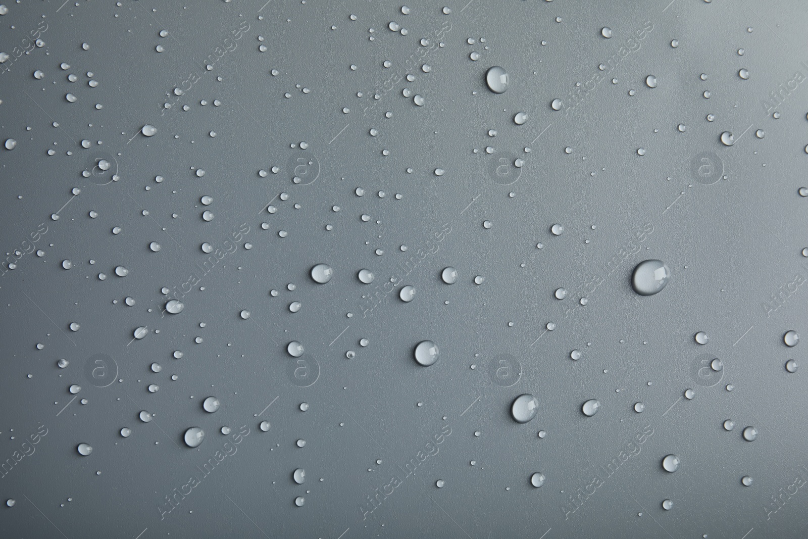 Photo of Many clean water drops on grey background