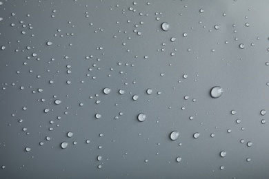 Many clean water drops on grey background