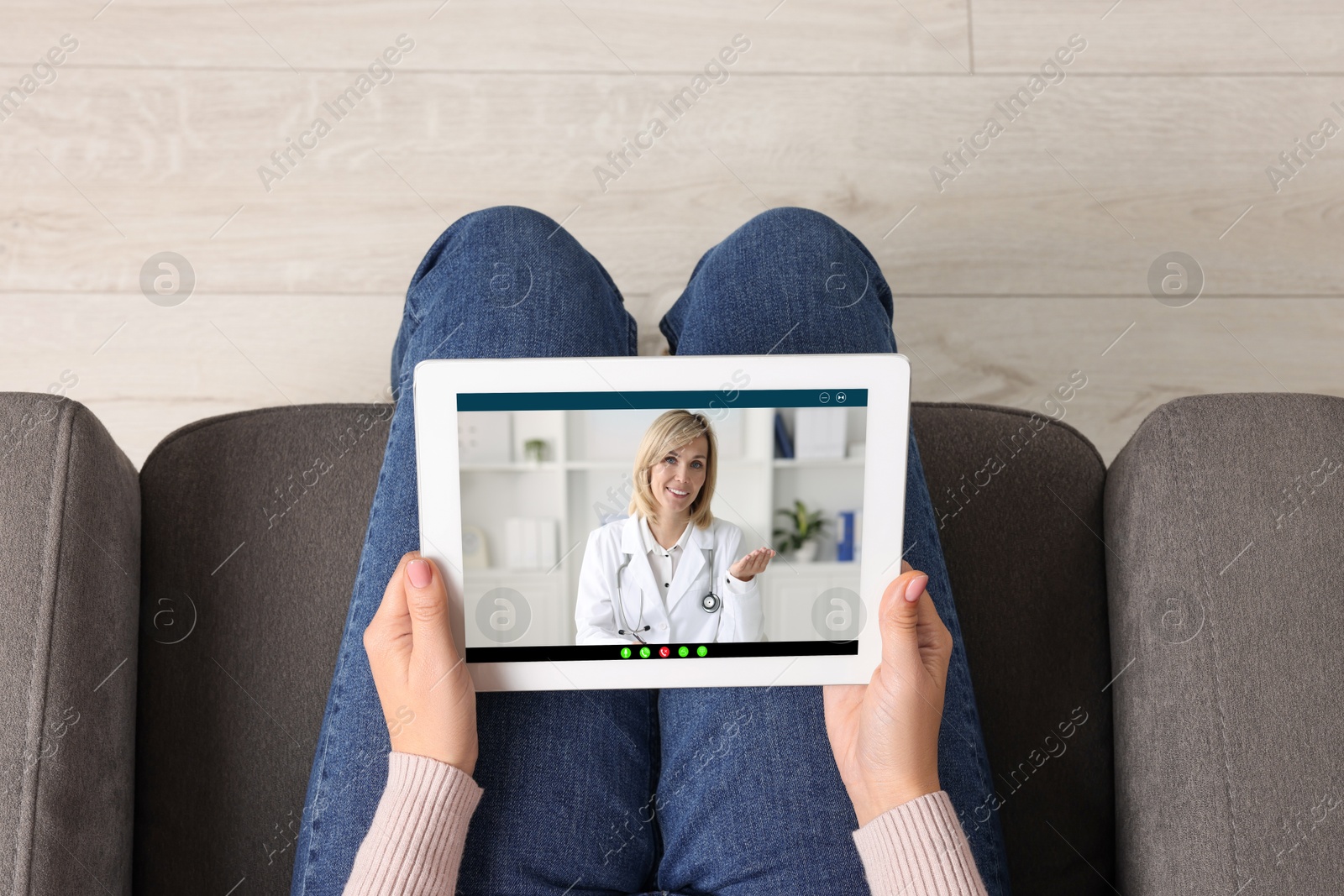 Image of Online medical consultation. Woman having video chat with doctor via tablet at home, top view