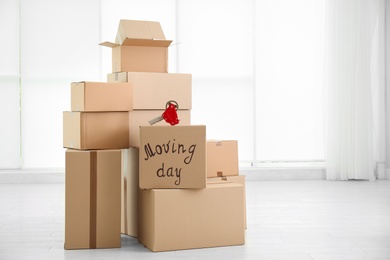 Photo of Pile of moving boxes in empty room