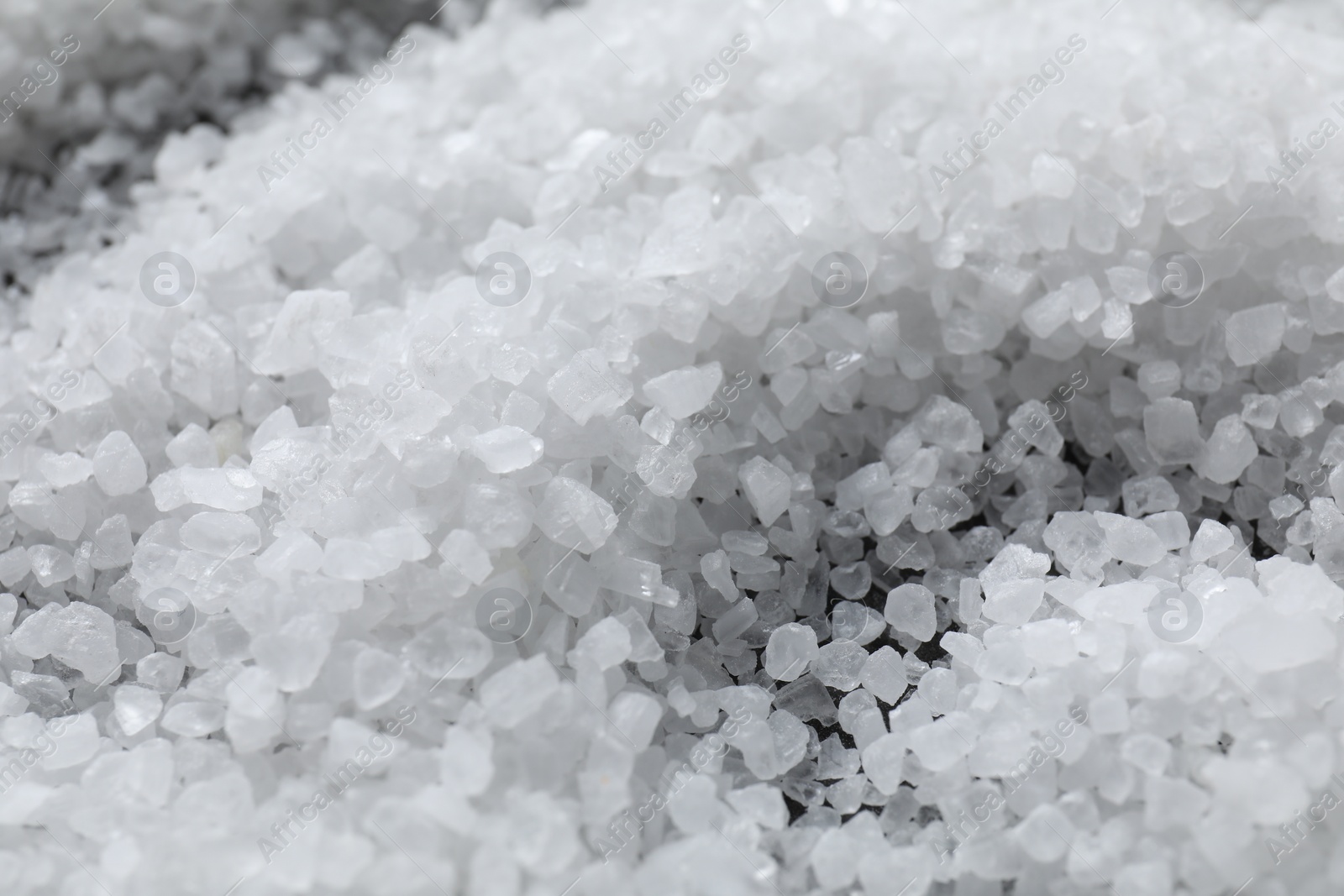 Photo of White natural salt as background, closeup view