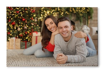 Image of Photo printed on canvas, white background. Happy young couple lying on floor in living room decorated for Christmas