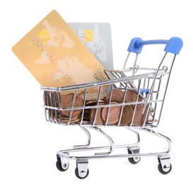 Photo of Small metal shopping cart with credit cards and coins isolated on white