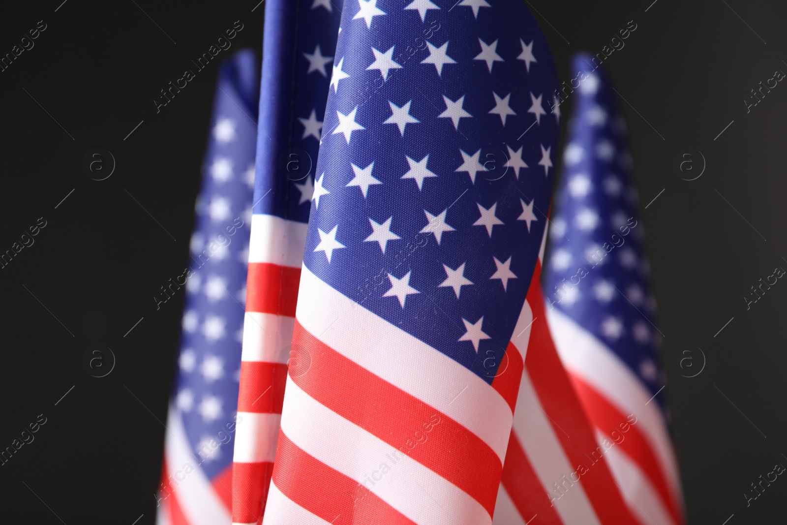 Photo of National flags of America on black background. Memorial day celebration