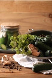 Fresh cucumbers, dill, peppercorns and garlic on wooden table. Pickling recipe