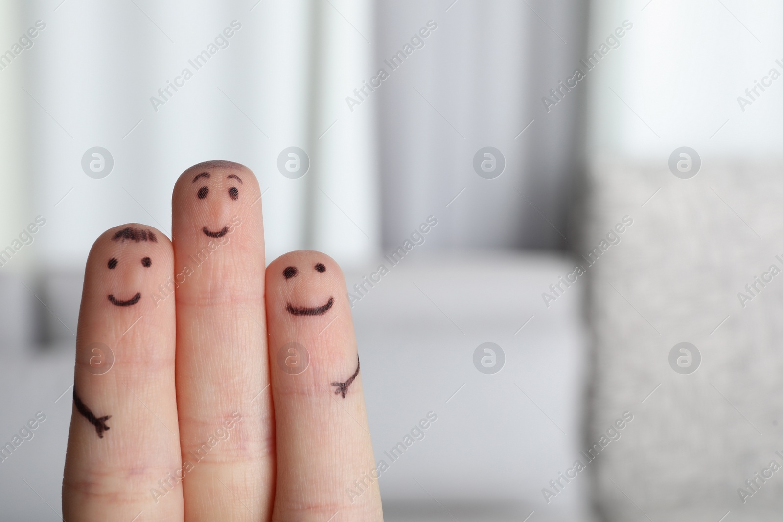 Photo of Three fingers with drawings of happy faces on blurred background, space for text