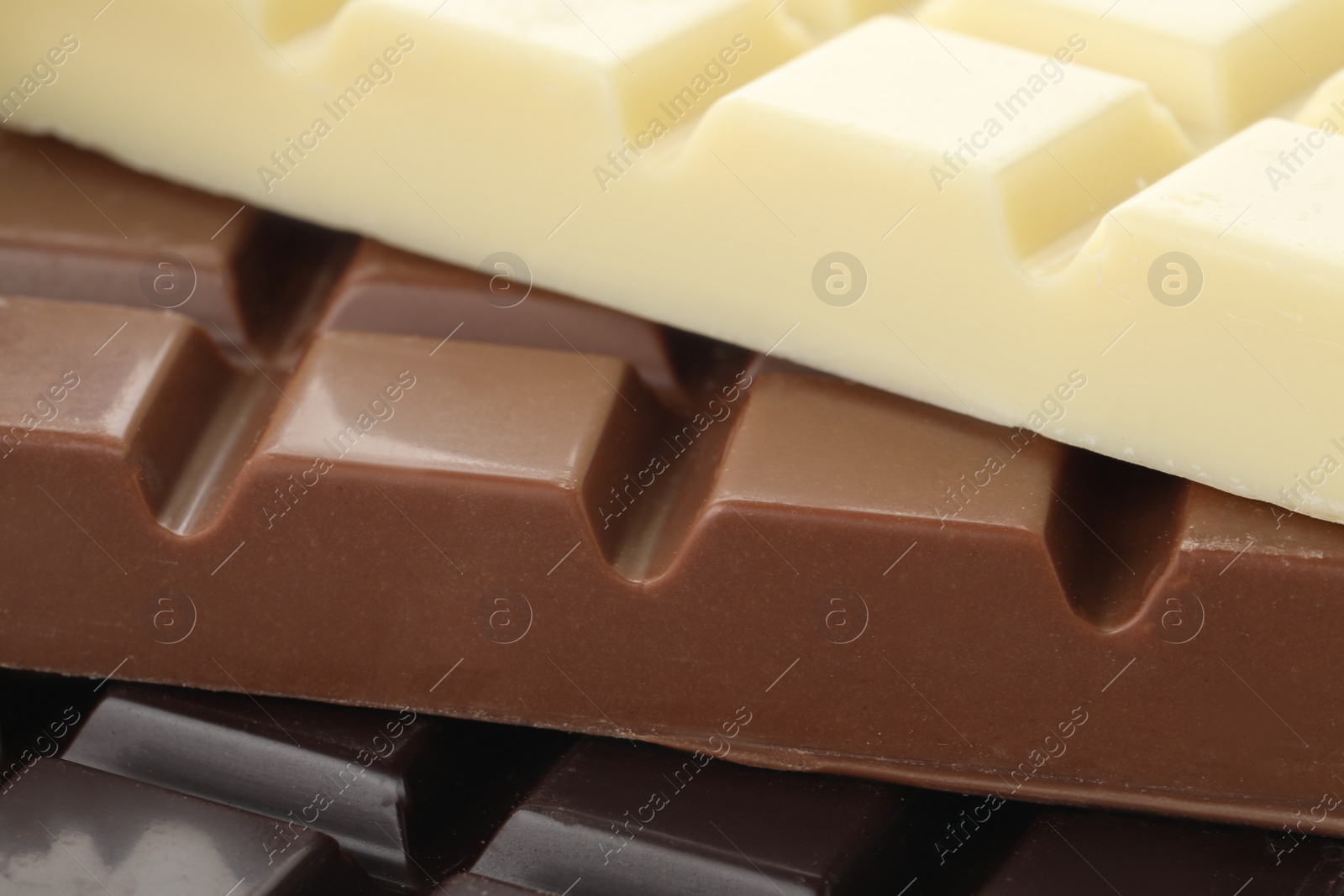 Photo of Different delicious chocolate as background, closeup view