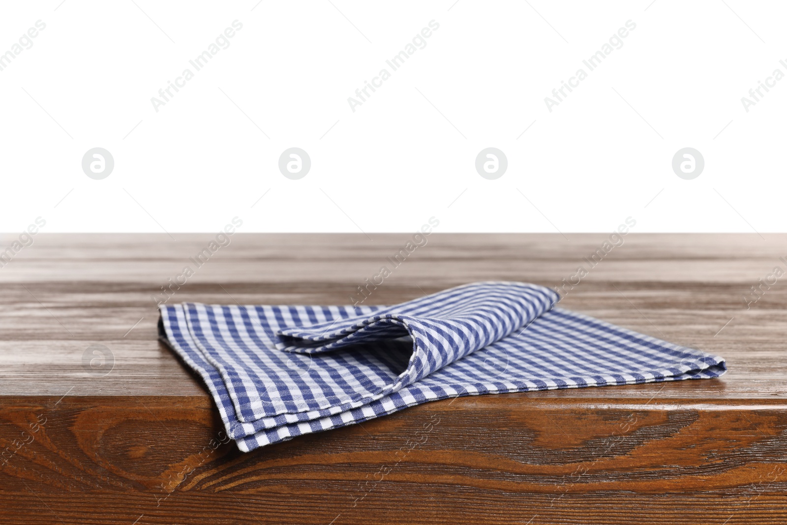 Photo of Checkered tablecloth on wooden table against white background