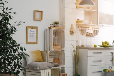 Photo of Modern kitchen interior with wooden crates as eco furniture