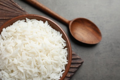 Photo of Bowl of cooked white rice served on table, flat lay. Space for text