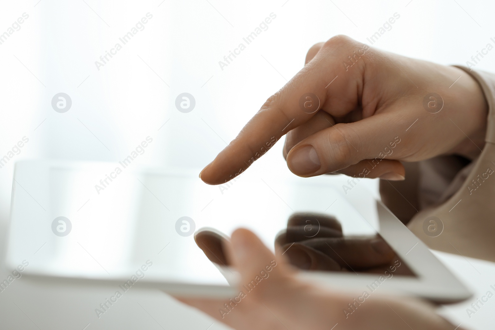 Photo of Closeup view of woman using modern tablet on blurred background