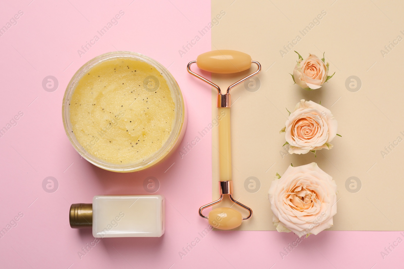 Photo of Skin care products, beautiful roses and face roller on color background