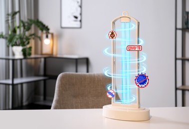 Image of UV sterilizer lamp on table at home. Space for text