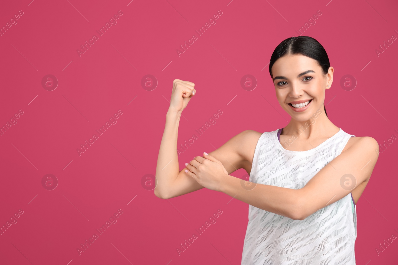 Photo of Strong woman as symbol of girl power on pink background, space for text. 8 March concept