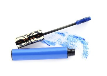 Photo of Applicator, mascara for eyelashes and blue smear on white background, top view