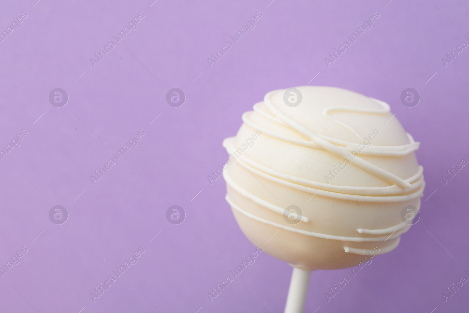 Photo of Sweet cake pop on purple background, space for text