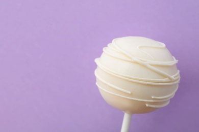 Sweet cake pop on purple background, space for text