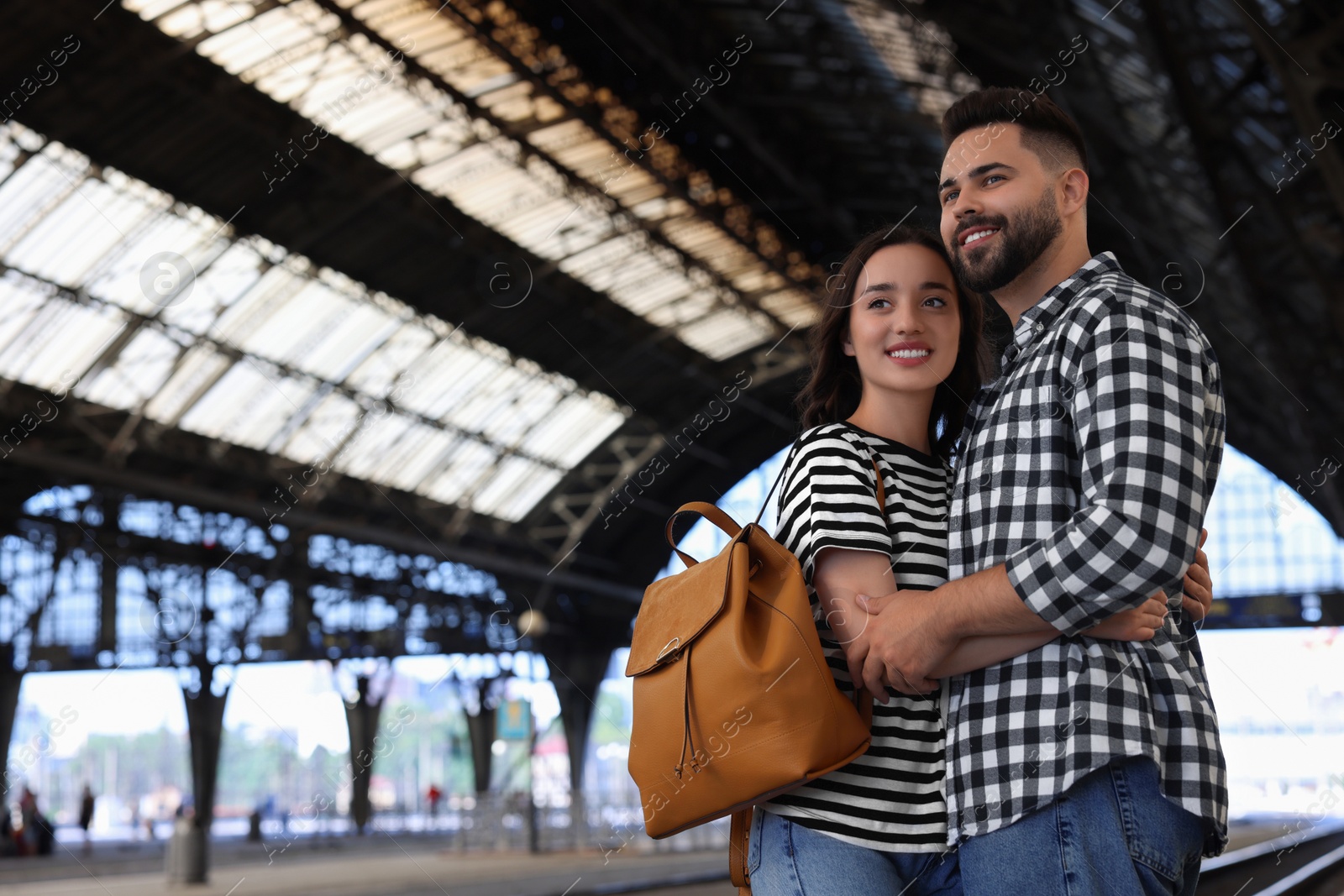 Photo of Long-distance relationship. Beautiful couple on platform of railway station, space for text