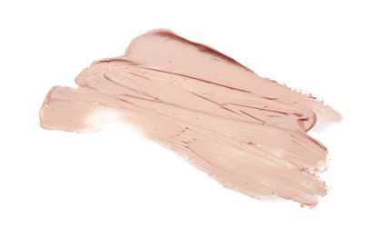Photo of Strokes of pink color correcting concealer isolated on white