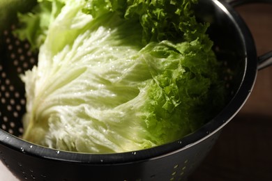 Photo of Fresh lettuce on brown table, closeup. Salad greens