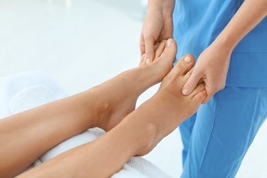 Woman receiving leg massage in wellness center, closeup