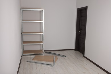 Office room with white walls and metal storage shelf