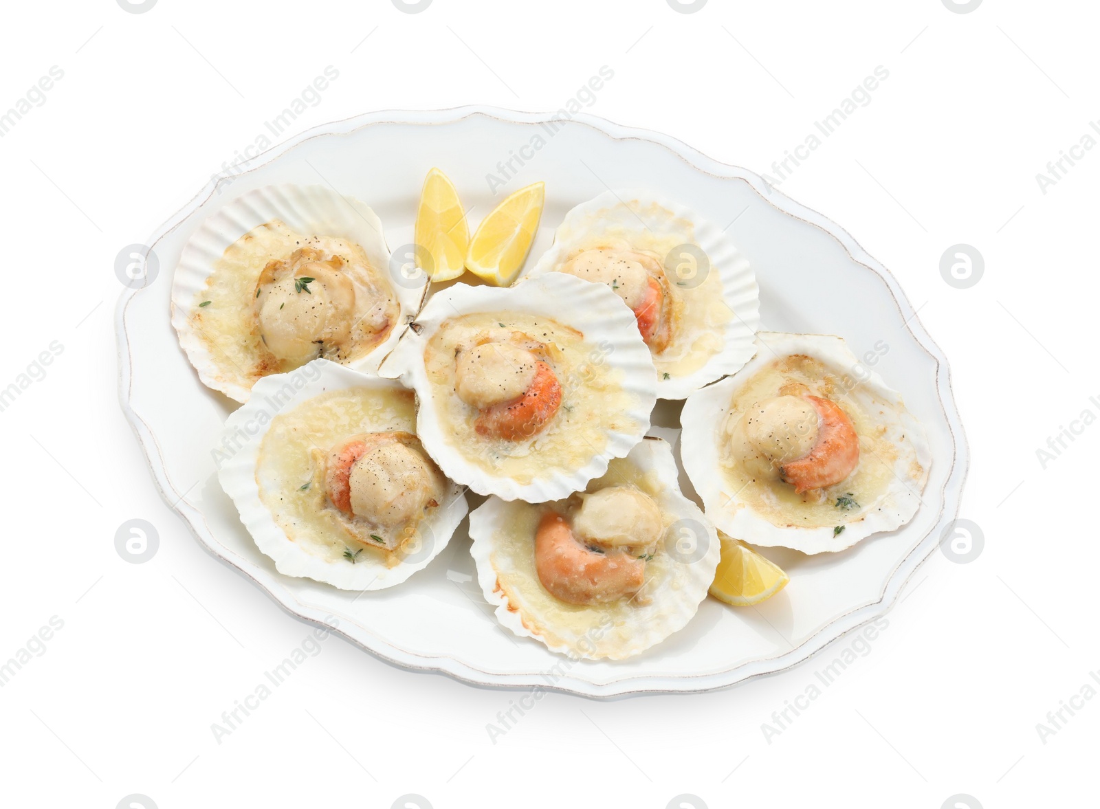 Photo of Fried scallops in shells and lemon isolated on white, top view