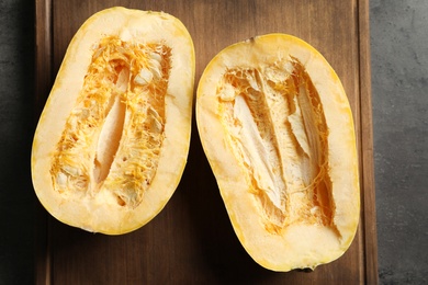 Photo of Cut spaghetti squash on wooden board, top view