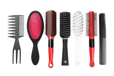 Set of hair brushes and combs isolated on white, top view