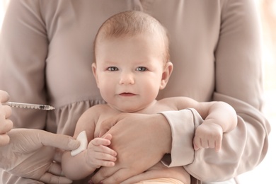 Doctor vaccinating baby in clinic