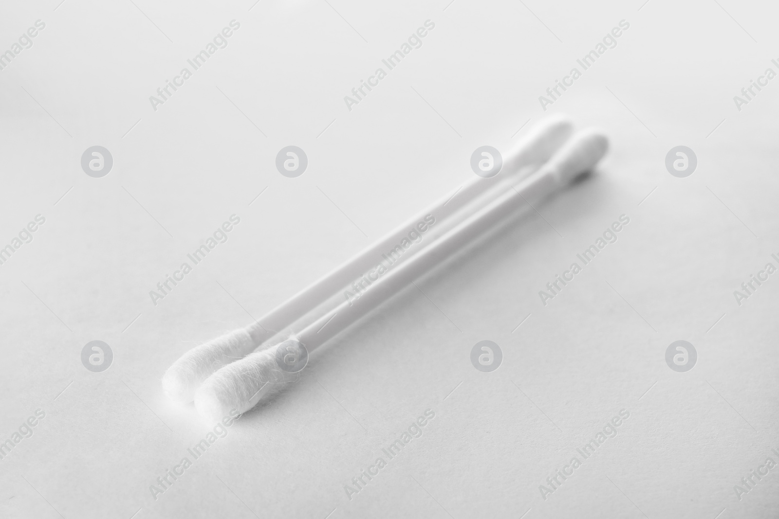 Photo of Clean cotton buds on white background. Hygienic accessory