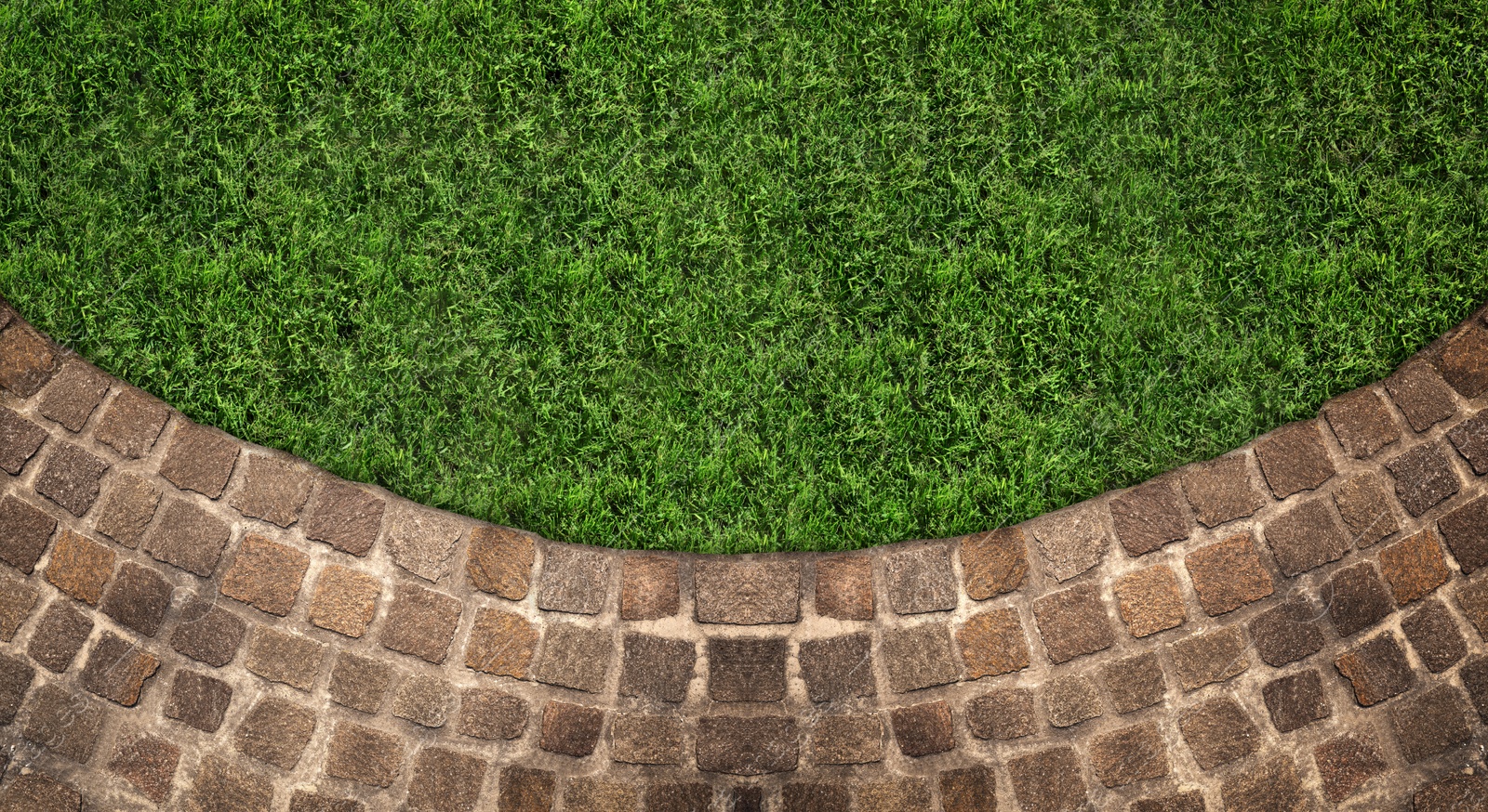 Image of Fresh green grass and stone tiles outdoors, top view. Banner design