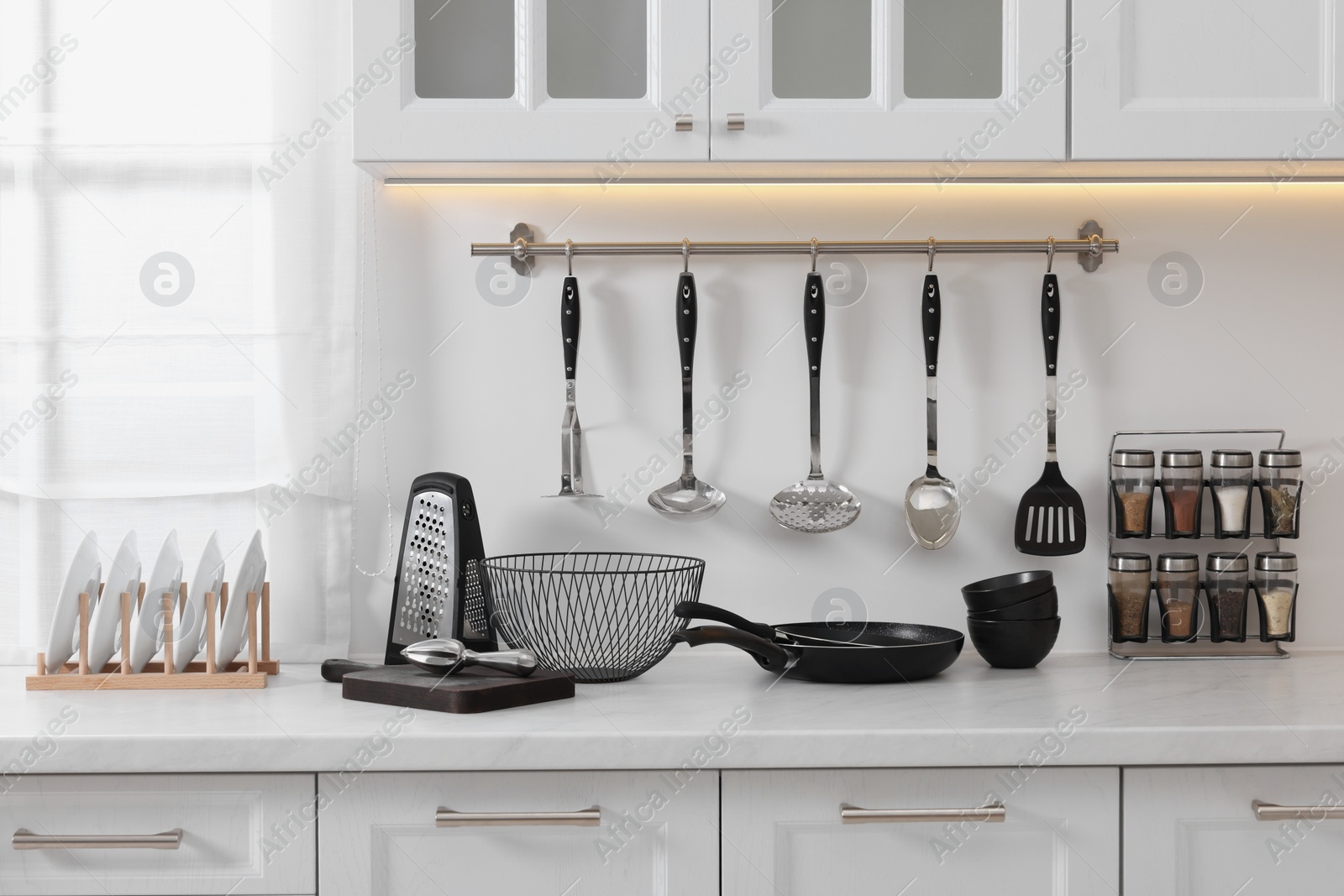 Photo of Set of different utensils on countertop in kitchen