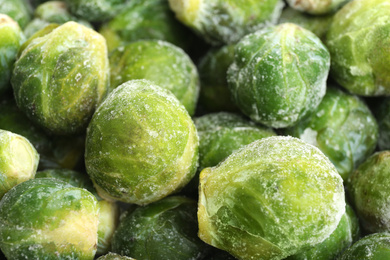 Photo of Frozen Brussels sprouts as background, closeup. Vegetable preservation