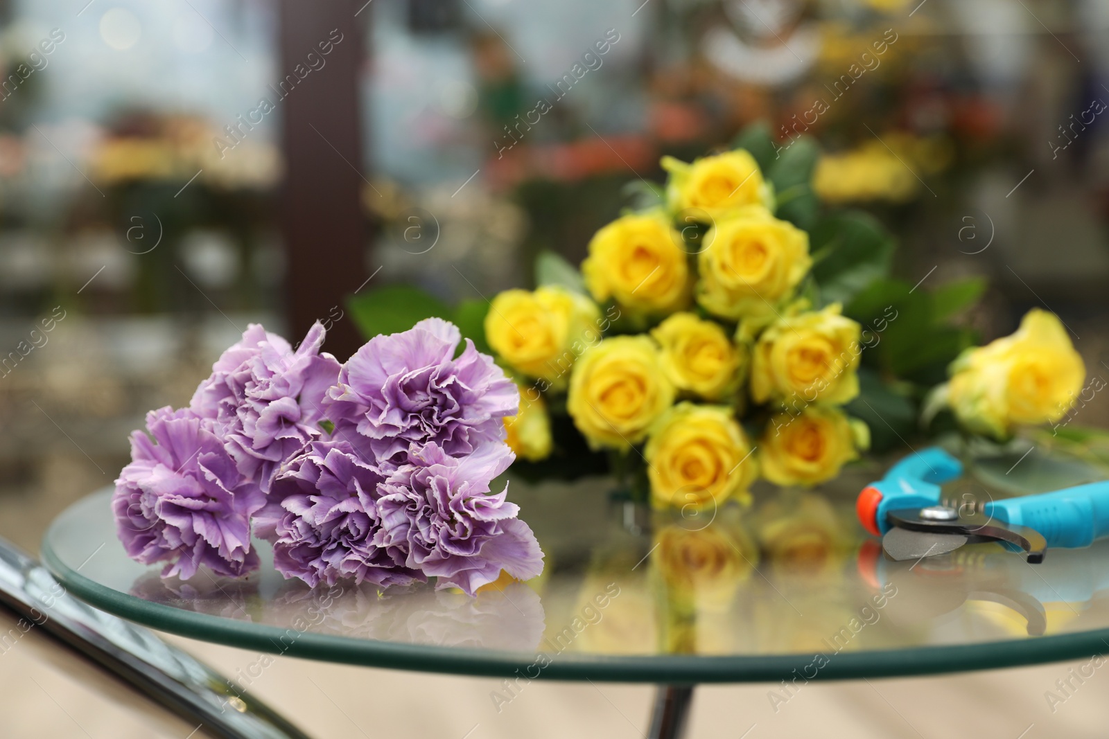 Photo of Beautiful bouquet on table in flower shop. Florist's workplace