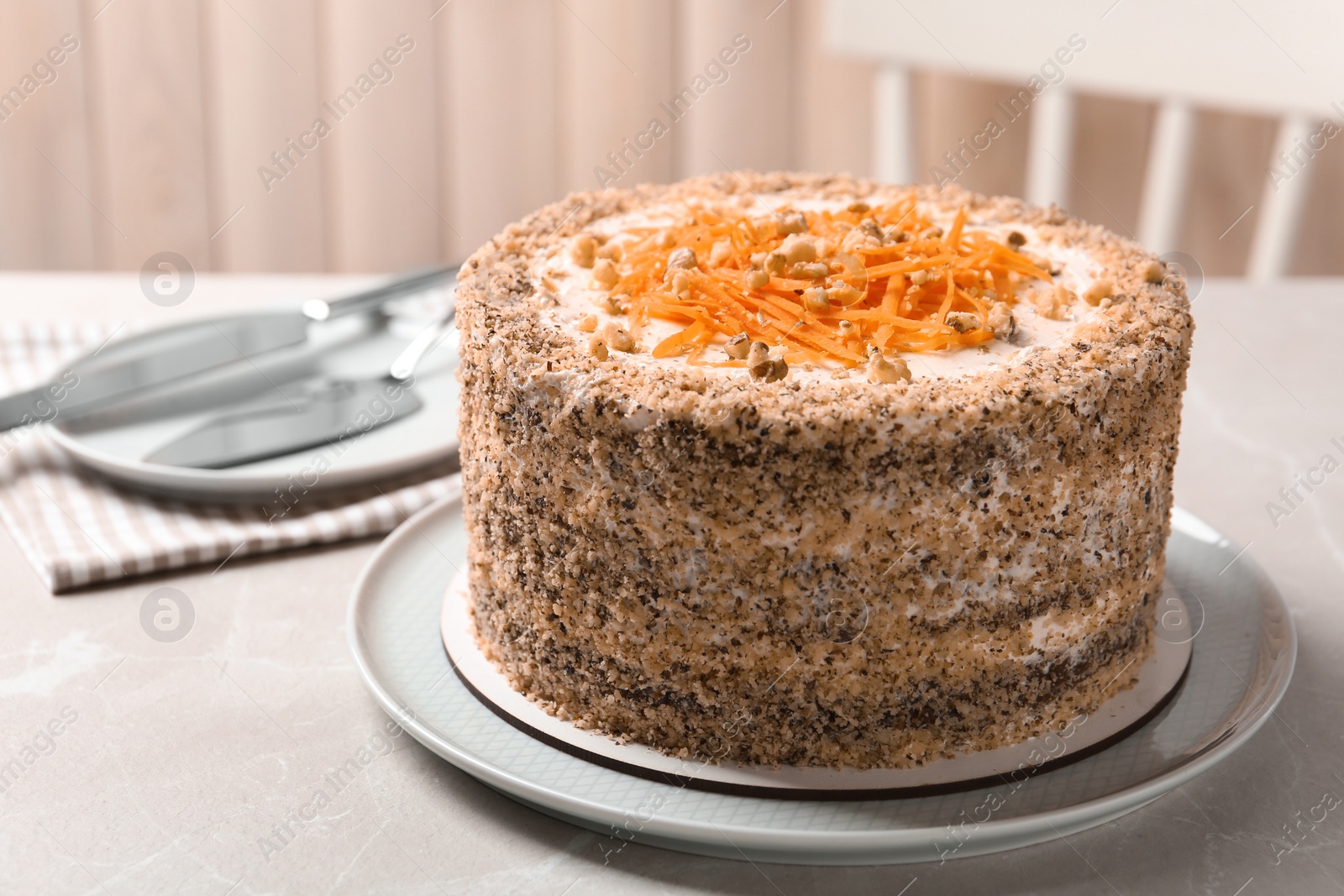 Photo of Sweet carrot cake with delicious cream on white marble table indoors, space for text