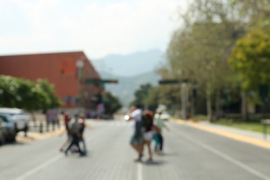 Photo of Blurred view of people crossing city street