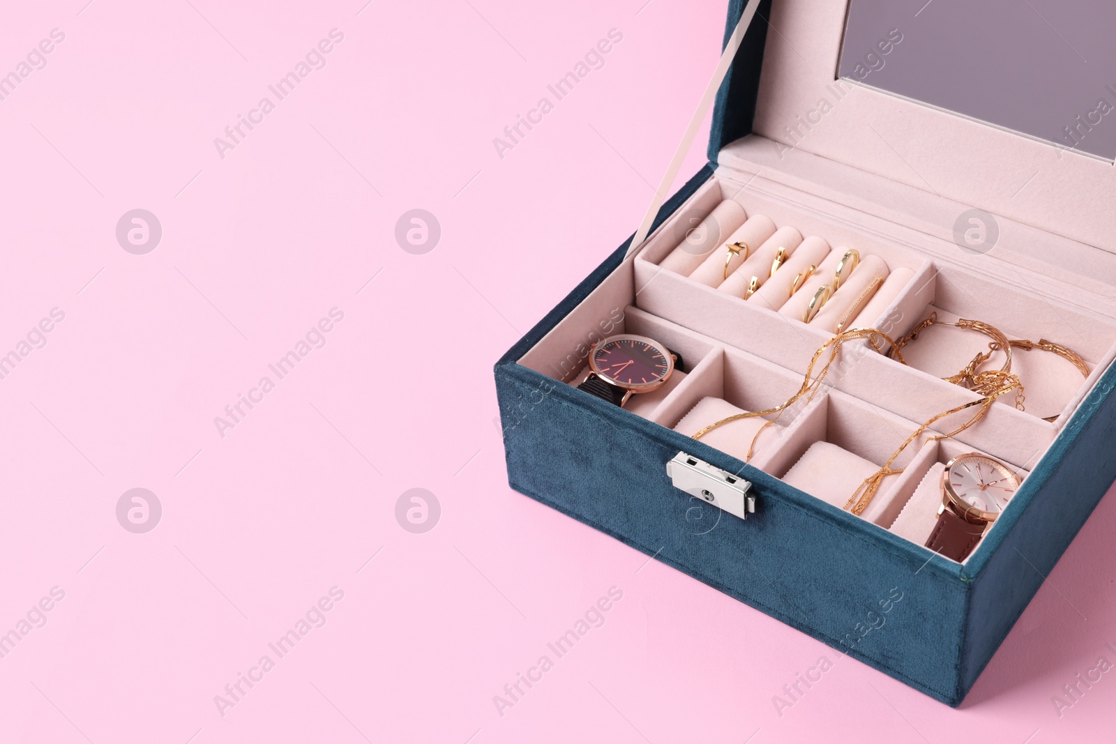 Photo of Jewelry box with many different accessories on pink background. Space for text