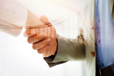 Image of Double exposure of bridge and business partners shaking hands indoors, closeup