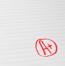 Image of School grade. Red letter A with plus symbol on notebook paper