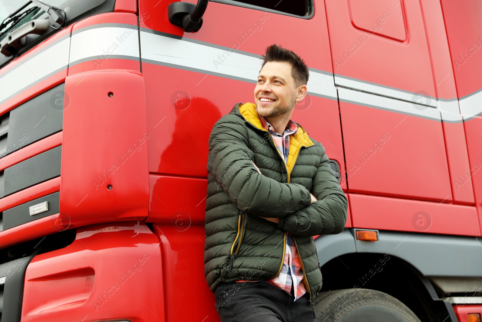 Photo of Portrait of happy driver at modern truck outdoors