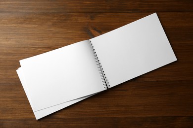 Photo of Blank paper brochure on wooden table, top view. Mockup for design