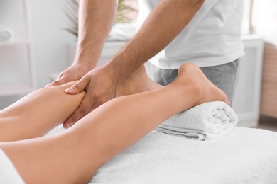 Young woman receiving massage in salon, closeup