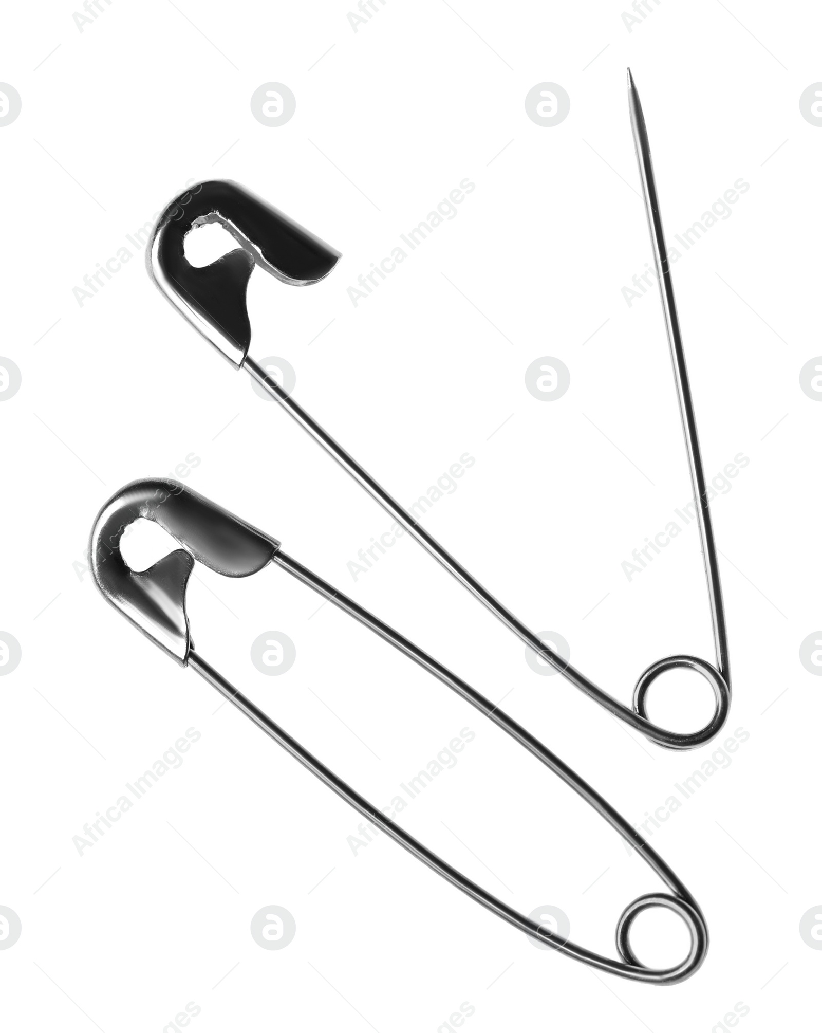 Photo of Metal safety pins on white background, top view