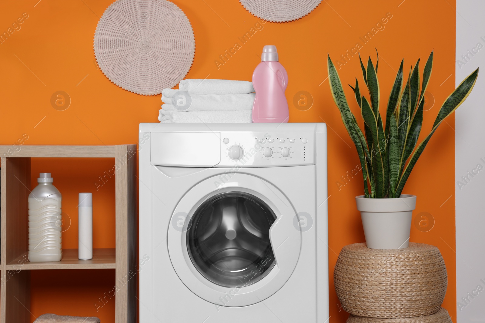 Photo of Stylish laundry room with washing machine. Interior design