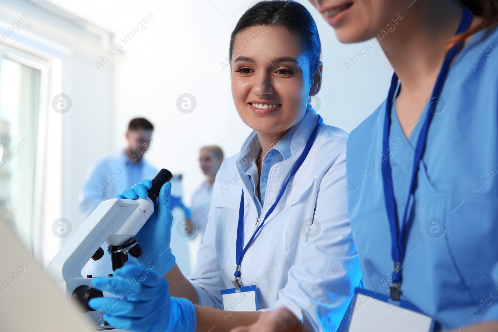 Photo of Group of scientists working in modern chemistry laboratory