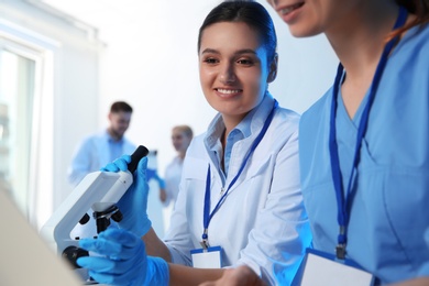 Group of scientists working in modern chemistry laboratory