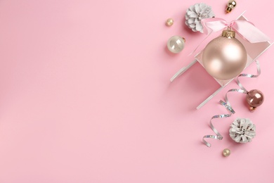 Photo of Beautiful Christmas composition with miniature sleigh on pink background, flat lay. Space for text