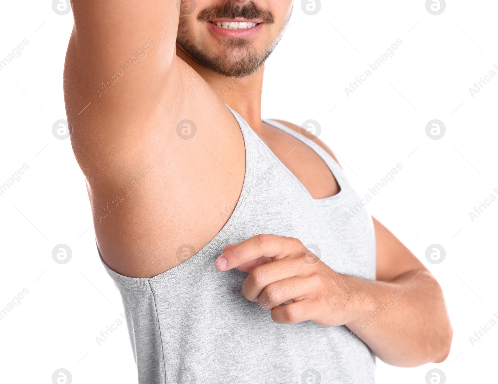 Photo of Young man showing armpit on white background, closeup. Using deodorant